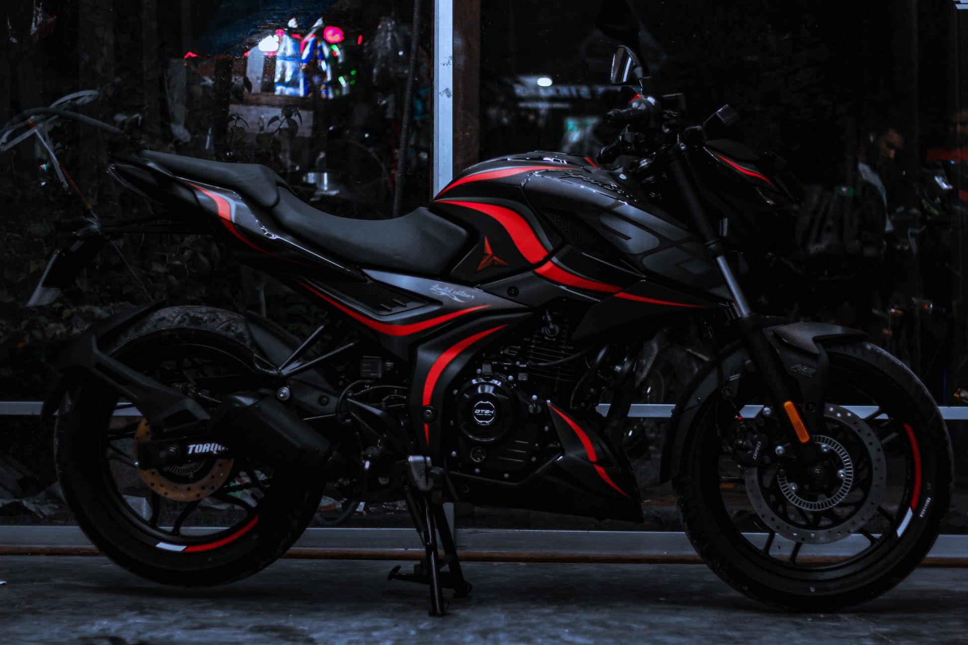 Side view of a motorcycle with an N160 Wave Decal Kit, featuring striking red and black wave patterns on the body.