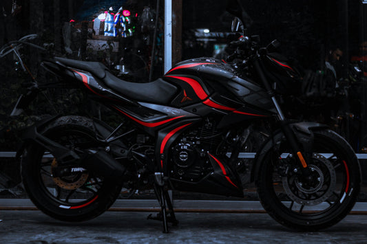 Side view of a motorcycle with an N160 Wave Decal Kit, featuring striking red and black wave patterns on the body.