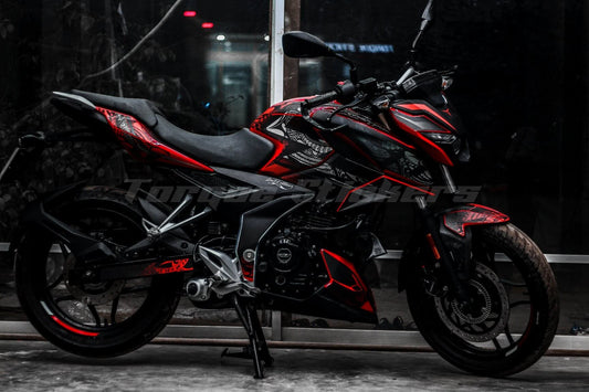 A black and red motorcycle with N160 Tribal decal kit, parked indoors with a reflective window behind.