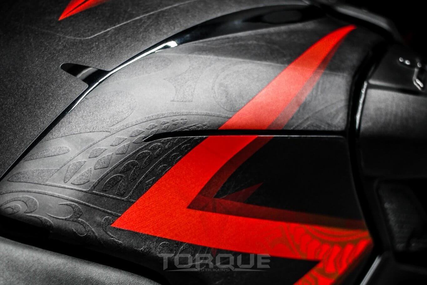 Close-up of a motorcycle's side panel featuring the red and black N160 Tribal Decal Kit design with intricate patterns.